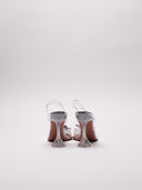 Immagine di scarpe slingback Amina Muaddi Begum in PVC trasparente con decori gioiello, su sfondo neutro.