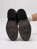   "Suole stivali Ann Demeulemeester con usura visibile"
  