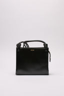 Borsa Jil Sander in pelle nera lucida con manici intrecciati.