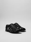 Sandali in pelle nera per uomo di LOEWE, vista laterale con dettaglio su misura artigianale.