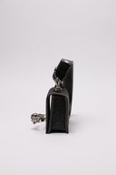 Clutch MCQUEEN in denim con dettagli decorativi a teschio 
